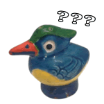 sticker of a small cermic bird with a crazy look on his face and question marks above his head
